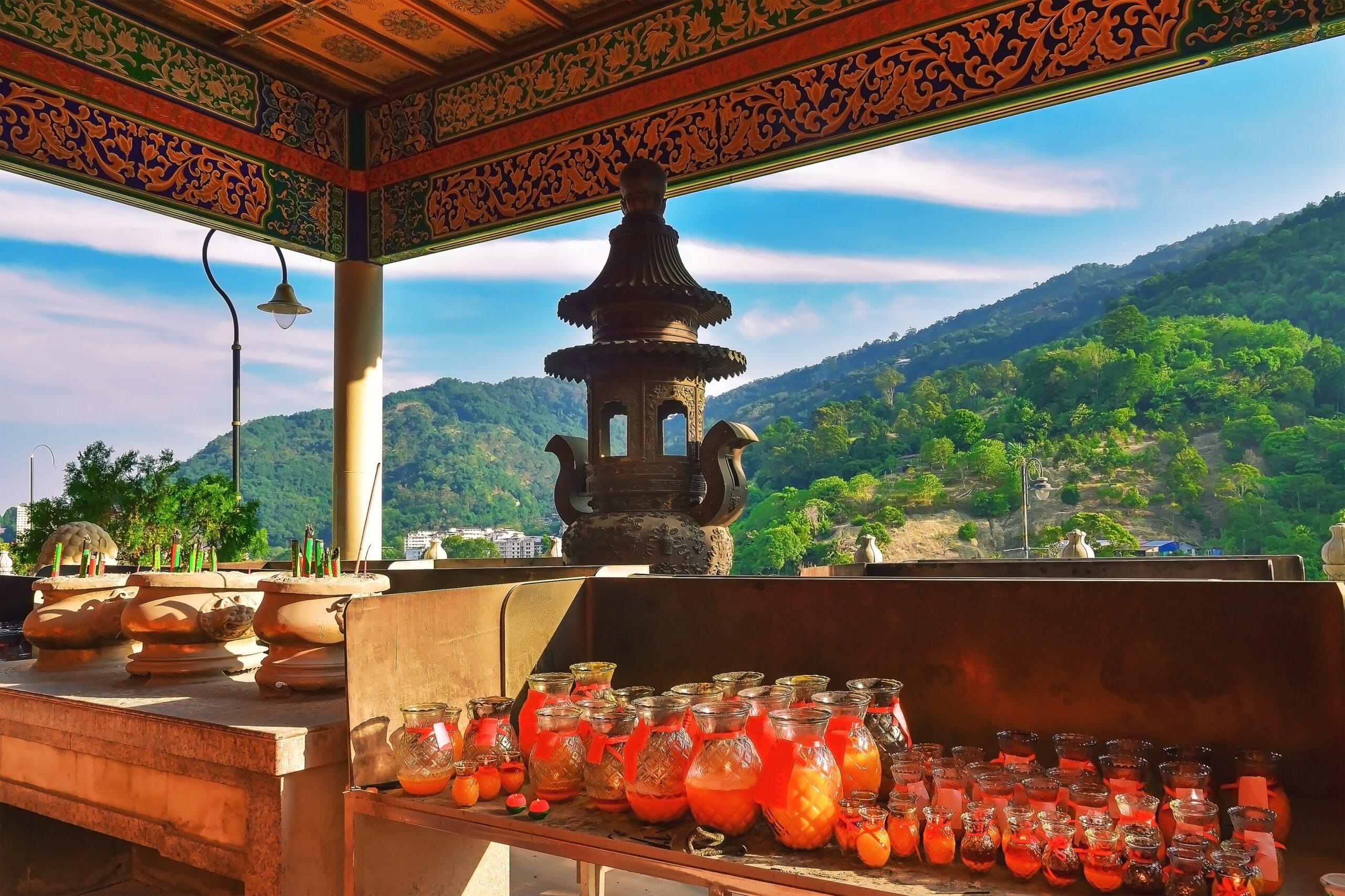 Bottles of wishing candles in Kek Lok Si temple and view of the mountain. Penang, Malaysia